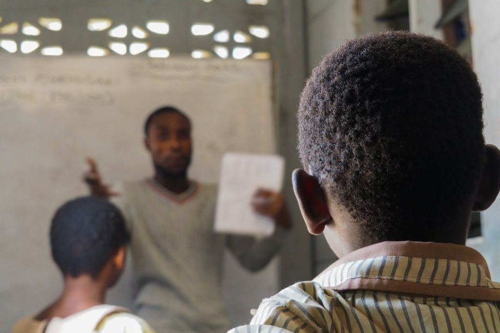 A teacher guiding students in a classroom - GREEN STEM Schools and Clubs
